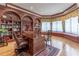 Office showcasing custom built-in shelves, a large desk, and hardwood floors at 8470 Lazy Oaks Ct, Atlanta, GA 30350
