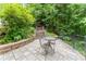 Stunning outdoor patio offers a serene retreat with stone steps, lush greenery, and peaceful surroundings at 8470 Lazy Oaks Ct, Atlanta, GA 30350