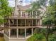 Elevated rear view of home with large decks and lush landscaping at 8470 Lazy Oaks Ct, Atlanta, GA 30350