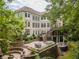 Elevated rear view of home with multiple decks and lush landscaping at 8470 Lazy Oaks Ct, Atlanta, GA 30350
