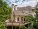 Elevated rear view of home with large decks and lush landscaping at 8470 Lazy Oaks Ct, Atlanta, GA 30350