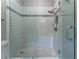 Bright shower featuring white subway tiles and a glass door at 8470 Lazy Oaks Ct, Atlanta, GA 30350