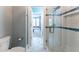 Glass shower with subway tile surround, blue glass accents, and recessed shelving at 8470 Lazy Oaks Ct, Atlanta, GA 30350