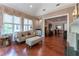 Sitting room featuring hardwood floors, fireplace, wet bar, and natural light, perfect for relaxation at 8470 Lazy Oaks Ct, Atlanta, GA 30350