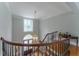 Elegant staircase with wrought iron railings and a stylish pendant light fixture above at 8470 Lazy Oaks Ct, Atlanta, GA 30350