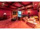 Home theater with red decor, coffered ceilings, and comfortable seating for watching movies at 8470 Lazy Oaks Ct, Atlanta, GA 30350
