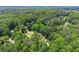 A scenic aerial view displays a lovely home surrounded by a canopy of mature trees at 1713 Dudley Dr, Woodstock, GA 30188