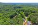 A picturesque aerial view of a charming home nestled amidst lush greenery and mature trees at 1713 Dudley Dr, Woodstock, GA 30188