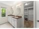 Elegant bathroom featuring a double vanity, and access to a walk-in closet at 1713 Dudley Dr, Woodstock, GA 30188