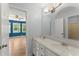 Bathroom featuring double sinks, vanity, and mirrors, with an open doorway to a bedroom at 1713 Dudley Dr, Woodstock, GA 30188