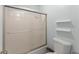 Bright bathroom features a shower-tub combination with sliding glass doors and modern fixtures at 1713 Dudley Dr, Woodstock, GA 30188