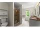 Elegant bathroom featuring a glass shower, double sinks, and ample cabinet space at 1713 Dudley Dr, Woodstock, GA 30188