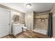 Bathroom showcasing a single vanity, toilet, and walk-in shower with decorative tiling at 1713 Dudley Dr, Woodstock, GA 30188