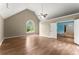 Bedroom with vaulted ceiling, arched window, ceiling fan and doorway to another living space at 1713 Dudley Dr, Woodstock, GA 30188