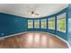 Inviting bedroom with hardwood floors, multiple windows, and a modern ceiling fan at 1713 Dudley Dr, Woodstock, GA 30188