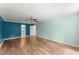 Bright bedroom showcasing hardwood floors, a modern ceiling fan, and light-filled windows at 1713 Dudley Dr, Woodstock, GA 30188