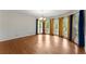 Spacious dining room featuring hardwood floors and large windows with elegant curtains at 1713 Dudley Dr, Woodstock, GA 30188