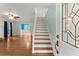Inviting foyer featuring hardwood floors, staircase, and views into the living spaces at 1713 Dudley Dr, Woodstock, GA 30188
