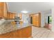 Well-lit kitchen featuring wooden cabinets, granite countertops, and stainless steel appliances at 1713 Dudley Dr, Woodstock, GA 30188