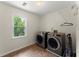 Laundry room featuring a large window, modern appliances, and storage racks at 1713 Dudley Dr, Woodstock, GA 30188