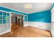 Spacious living room with hardwood floors, large windows, and bright blue accent wall at 1713 Dudley Dr, Woodstock, GA 30188