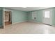 Spacious living room with tile floors and neutral walls, leading to an updated bathroom at 1713 Dudley Dr, Woodstock, GA 30188