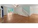 Open-concept living room featuring hardwood floors, fireplace, and staircase to the second floor at 1713 Dudley Dr, Woodstock, GA 30188
