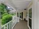 Charming covered front porch with white railings, offering a cozy outdoor space at 1713 Dudley Dr, Woodstock, GA 30188