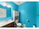 Cozy powder room featuring blue walls, a pedestal sink, and convenient storage at 1713 Dudley Dr, Woodstock, GA 30188
