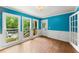 Bright sunroom with hardwood floors, large windows, and access to the backyard at 1713 Dudley Dr, Woodstock, GA 30188