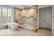 Modern bathroom showcasing a glass shower enclosure, soaking tub, and tile flooring at 185 Pebble Trl, Alpharetta, GA 30009