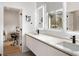 The bright bathroom has dual sinks, modern fixtures, and stylish mirrors under natural light at 185 Pebble Trl, Alpharetta, GA 30009