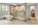 Bright bathroom featuring a glass shower enclosure, soaking tub, and walk-in closet at 185 Pebble Trl, Alpharetta, GA 30009
