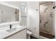 Sleek bathroom featuring a floating vanity, black fixtures, and a marble tiled shower at 185 Pebble Trl, Alpharetta, GA 30009