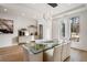 Bright dining room features a glass table, sleek lighting, and built-in buffet at 185 Pebble Trl, Alpharetta, GA 30009