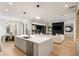 Modern kitchen features a spacious island, stainless steel appliances, and open layout with view into the living area at 185 Pebble Trl, Alpharetta, GA 30009