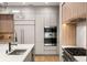 Sleek kitchen design featuring modern appliances, custom cabinets, and a stylish sink at 185 Pebble Trl, Alpharetta, GA 30009
