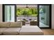 Spacious living area with comfortable seating and a view of the outdoor living space and pool at 185 Pebble Trl, Alpharetta, GA 30009