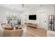Sun-filled living room featuring sewing tables, a TV, and comfortable seating at 185 Pebble Trl, Alpharetta, GA 30009