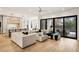 Open living room with modern kitchen, dining area, and access to backyard at 185 Pebble Trl, Alpharetta, GA 30009