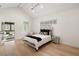 Bright main bedroom featuring hardwood floors, vaulted ceiling, and a sunroom view at 185 Pebble Trl, Alpharetta, GA 30009