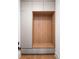 Mud room features a custom wood and gray storage nook and wood floors at 185 Pebble Trl, Alpharetta, GA 30009