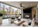 Outdoor patio features a cozy seating area with a fireplace, TV, and a view of the pool at 185 Pebble Trl, Alpharetta, GA 30009