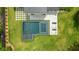 An aerial shot of a modern pool with an integrated jacuzzi and lounge chairs, surrounded by a lush, green lawn at 185 Pebble Trl, Alpharetta, GA 30009