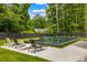 A modern swimming pool surrounded by lush greenery and comfortable lounge chairs at 185 Pebble Trl, Alpharetta, GA 30009