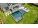 An aerial view of a modern backyard pool with an integrated spa and lounge chairs, set in a well-manicured lawn at 185 Pebble Trl, Alpharetta, GA 30009