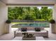 Inviting outdoor seating area offers a peaceful view of the pool and landscaped backyard at 185 Pebble Trl, Alpharetta, GA 30009