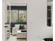 The sunroom has comfortable seating with neutral and black decor at 185 Pebble Trl, Alpharetta, GA 30009