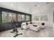 Sunroom showcasing floor to ceiling windows, comfortable seating, and exercise equipment at 185 Pebble Trl, Alpharetta, GA 30009