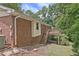 Exterior view of the brick house with a back deck and stairs leading to the yard at 3327 Spring Meadow Ct, Tucker, GA 30084